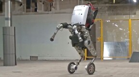 Handle from Boston Dynamics: robot with wheels and a suction arm